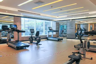 a gym with a lot of treadmills and exercise bikes at Frank Porter - Damac Cour Jardin in Dubai