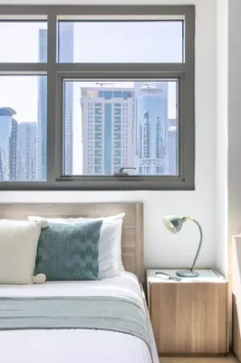 a bedroom with a large window and a bed at Frank Porter - Yach Bay in Dubai