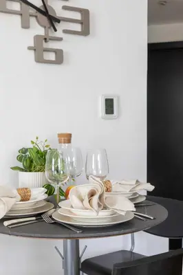 a dining room table with plates and wine glasses at Frank Porter - Yach Bay in Dubai