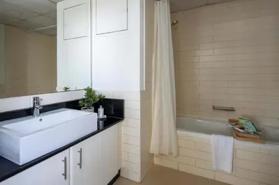 a bathroom with a sink and a bath tub at Frank Porter - Yach Bay in Dubai