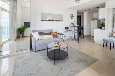 a living room with a couch and a table at Frank Porter - Yach Bay in Dubai