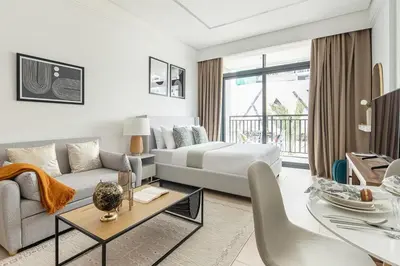 a hotel room with a bed and a couch and a table at Frank Porter - Sunrise Legend in Dubai