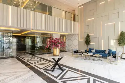 a lobby with a vase of flowers on a table at Frank Porter - Sunrise Legend in Dubai