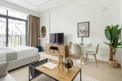 a hotel room with a bed and a table and a dining room at Frank Porter - Sunrise Legend in Dubai