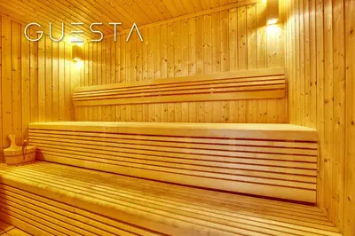 a wooden sauna with a bench in the middle at Sparkle Tower - Studio, Dubai Marina in Dubai