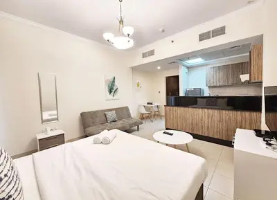 a living room with a table and a couch at RH- Relaxing Studio, Downtown with private balcony, walk away from Burj Khalifa in Dubai
