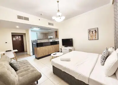 a living room with a large bed and a couch at RH- Relaxing Studio, Downtown with private balcony, walk away from Burj Khalifa in Dubai