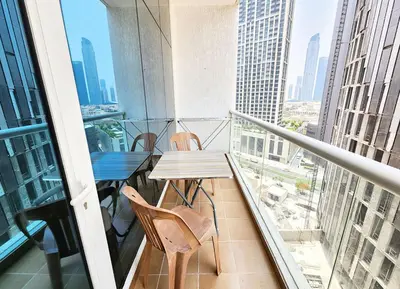 a balcony with a table and chairs on a building at RH- Relaxing Studio, Downtown with private balcony, walk away from Burj Khalifa in Dubai