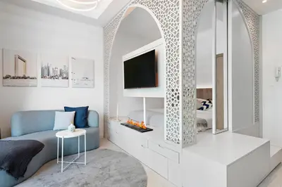 a bedroom with a bed and a tv and a mirror at Unique Dubai Marina Studio, near Jumeirah Beach, Mall and Metro in Dubai