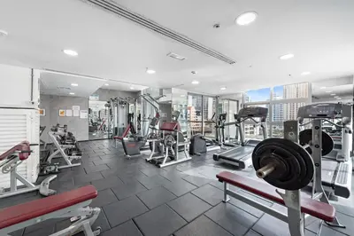 a gym with treadmills and machines in a building at Unique Dubai Marina Studio, near Jumeirah Beach, Mall and Metro in Dubai