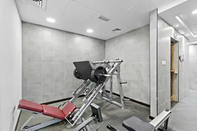 a gym with a red treadmill in a room at Unique Dubai Marina Studio, near Jumeirah Beach, Mall and Metro in Dubai