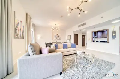 a living room with a couch and a table at Stylish 2BR At Shams 1 JBR by Deluxe Holiday Homes in Dubai