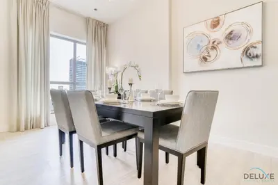 a dining room with a black table and chairs at Stylish 2BR At Shams 1 JBR by Deluxe Holiday Homes in Dubai