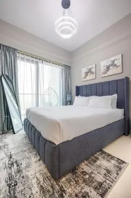 a large bed in a bedroom with a large window at ALiving Luxury 1BR with Canal View I Near Burj Khalifa & Dubai Mall I Zada Tower, 2613 in Dubai