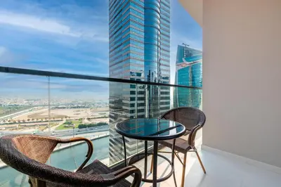 a balcony with a table and chairs and a view at ALiving Luxury 1BR with Canal View I Near Burj Khalifa & Dubai Mall I Zada Tower, 2613 in Dubai