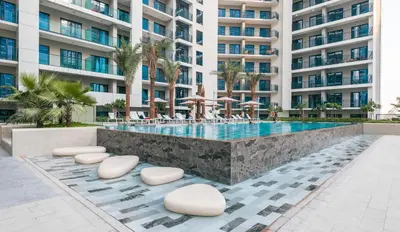 a swimming pool in front of a large apartment building at ALiving Luxury 1BR with Canal View I Near Burj Khalifa & Dubai Mall I Zada Tower, 2613 in Dubai