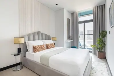 a white bedroom with a large bed and a window at Frank Porter - 15 Northside Tower 2 in Dubai