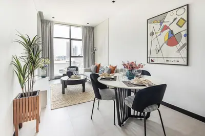a white living room with a table and chairs at Frank Porter - 15 Northside Tower 2 in Dubai