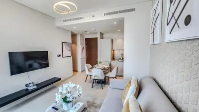 a living room with a couch and a table at STAY BY LATINEM Luxury 1BR Holiday Home CVR A1513 near Burj Khalifa in Dubai