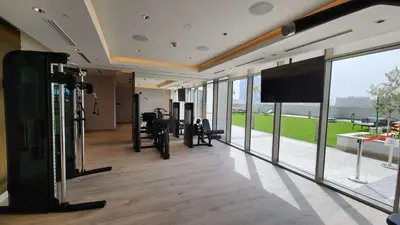 a gym with treadmills and a flat screen tv at STAY BY LATINEM Luxury 1BR Holiday Home CVR A1513 near Burj Khalifa in Dubai