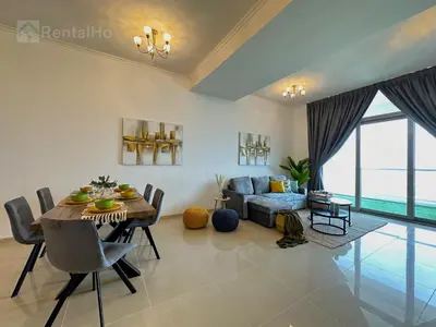 a living room with a table and a couch at Luxury Stop w/ BoHo Design & Sea View in Marina in Dubai