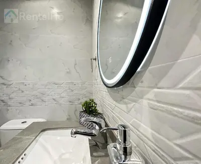 a bathroom sink with a mirror and a plant at Luxury Stop w/ BoHo Design & Sea View in Marina in Dubai