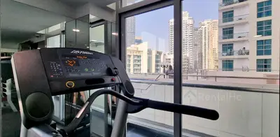 a gym with a view of a city from a building at Luxury Stop w/ BoHo Design & Sea View in Marina in Dubai