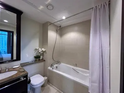a bathroom with a tub and a toilet and a sink at Durrani Homes - Alluring 5BR Penthouse with Burj Khalifa and Fountain View in Dubai