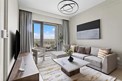 a living room with a couch and a table at Silkhaus luxurious 1BDR in new tower with pool & gym in Dubai