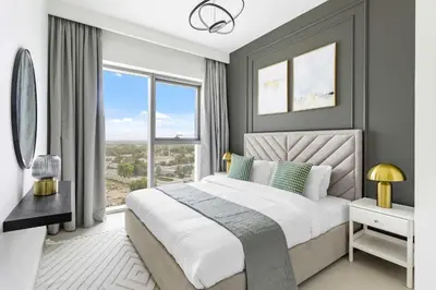 a bedroom with a large bed and a large window at Silkhaus modern & chic 1BDR in new tower with pool & gym in Dubai