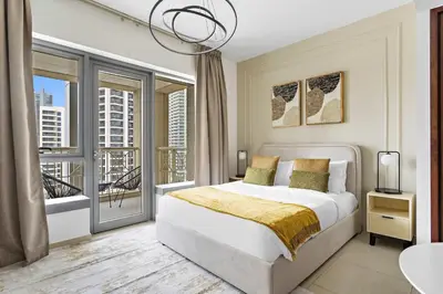 a bedroom with a bed and a large window at Silkhaus beautiful studio in Downtown near Burj Khalifa in Dubai