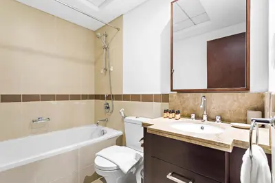a bathroom with a tub and a toilet and a sink at Silkhaus beautiful studio in Downtown near Burj Khalifa in Dubai