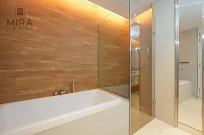 a bathroom with a tub and a shower at Mira Holiday Homes - Fully furnished 1 bedroom in Bluewater in Dubai