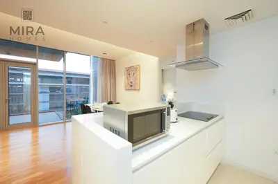 a kitchen with a tv on a counter at Mira Holiday Homes - Fully furnished 1 bedroom in Bluewater in Dubai