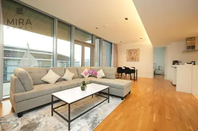 a living room with a couch and a table at Mira Holiday Homes - Fully furnished 1 bedroom in Bluewater in Dubai