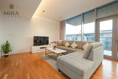 a living room with a couch and a tv at Mira Holiday Homes - Fully furnished 1 bedroom in Bluewater in Dubai