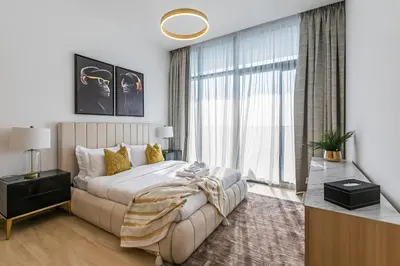 a bedroom with a large bed and a large window at Stunning 1 Bedroom Apartment - Regina Tower - JVC in Dubai