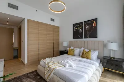 a bedroom with a large white bed in a room at Stunning 1 Bedroom Apartment - Regina Tower - JVC in Dubai