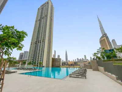 a swimming pool with a view of a city at Silkhaus lavish 1BDR in new tower with pool & gym access in Dubai