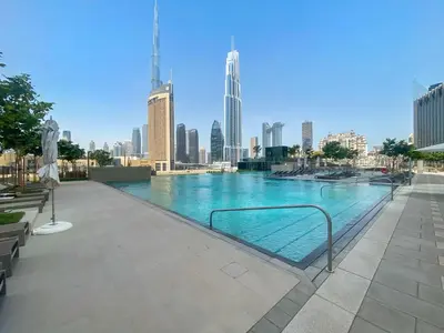 a swimming pool with a city skyline in the background at Silkhaus lavish 1BDR in new tower with pool & gym access in Dubai