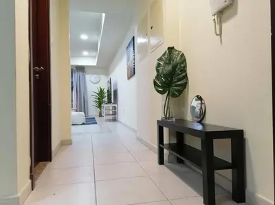 a hallway with a black table and a plant at Most enjoyable 2BR apartment in Dubai marina in Dubai