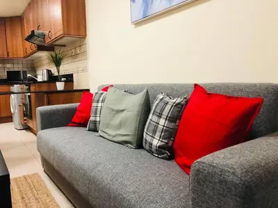 a gray couch with four pillows on it in a kitchen at Most enjoyable 2BR apartment in Dubai marina in Dubai
