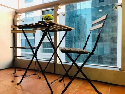 a table and a chair in front of a window at Most enjoyable 2BR apartment in Dubai marina in Dubai