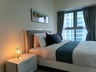 a bedroom with a large bed and a window at Most enjoyable 2BR apartment in Dubai marina in Dubai