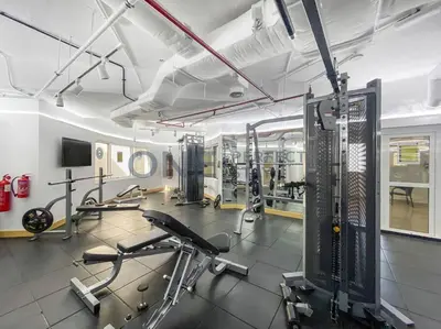a gym with several treadmills and cardio machines at Stunning Lake View - Height Floor - Furnished 1BR in Dubai