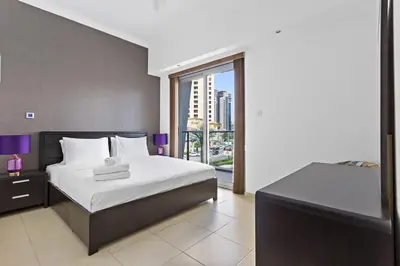 a hotel room with a bed and a large window at 3-5 mins walk to JBR 5-7 mins to the tram in Dubai