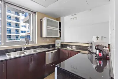 a kitchen with a sink and a microwave at 3-5 mins walk to JBR 5-7 mins to the tram in Dubai