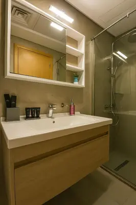 a bathroom with a sink and a shower at Cozy Apartment in Jumeirah Village Circle, Dubai. in Dubai
