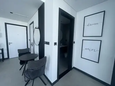 a room with a table and chairs and a mirror at Iconic !Luxurious 1 Bed Apartment! in Dubai