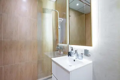 a bathroom with a white sink and a mirror at Le Villa-Joie !Bright Studio Apartment! in Dubai